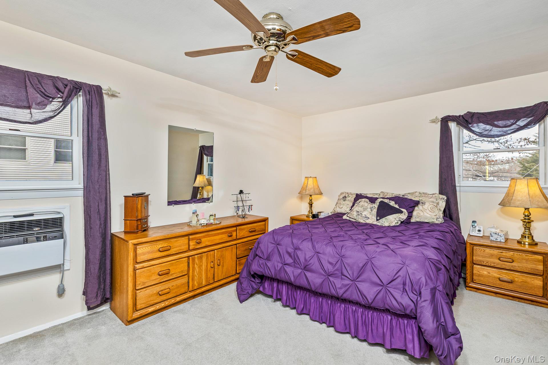 173 Fifty Acre Road South Smithtown, NY 11787 - Photo 24 of 42 a bedroom with a bed and a chandelier