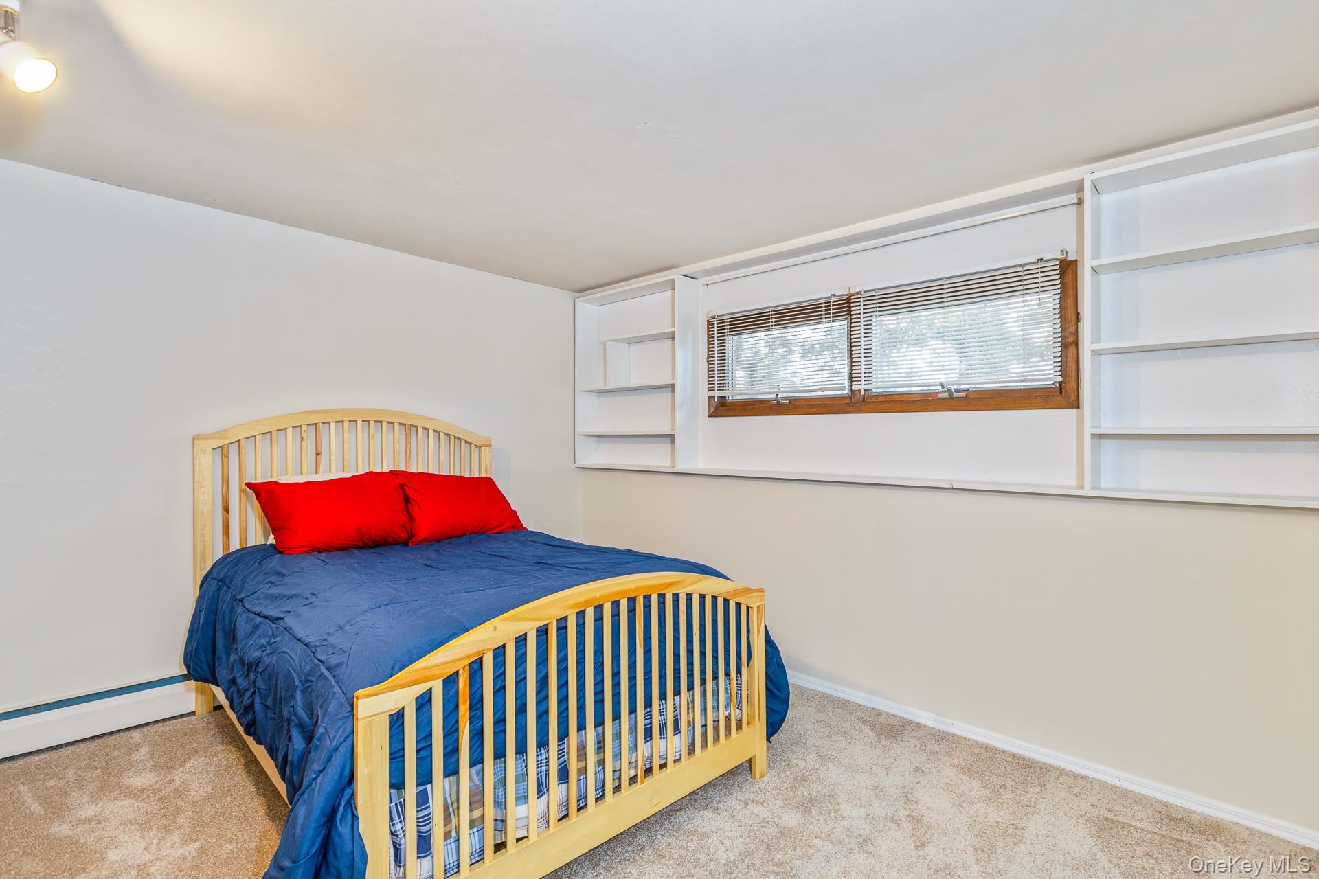 173 Fifty Acre Road South Smithtown, NY 11787 - Photo 32 of 42 a bedroom with a bed and window