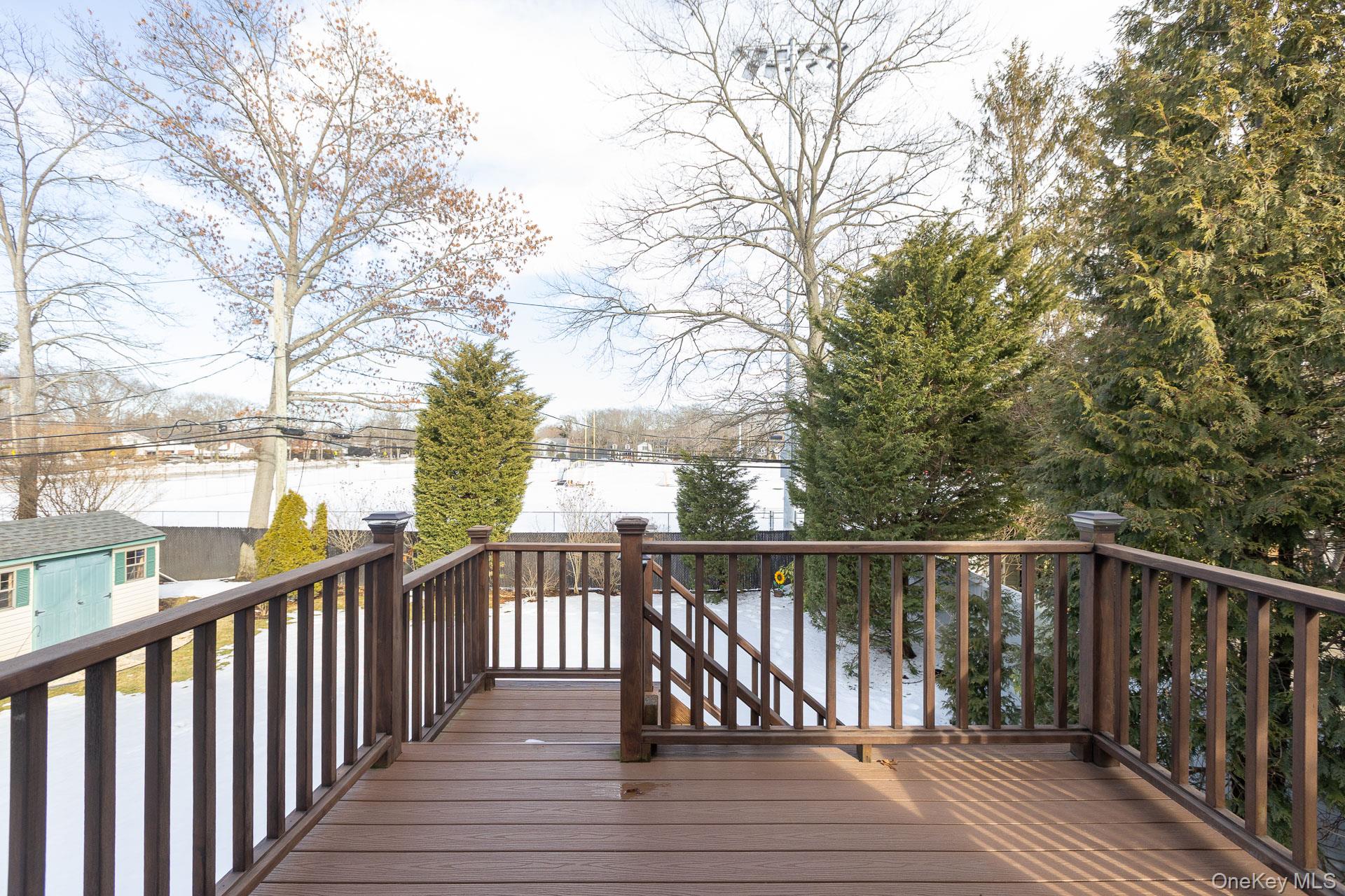 173 Fifty Acre Road South Smithtown, NY 11787 - Photo 38 of 42 a view of wooden deck with trees