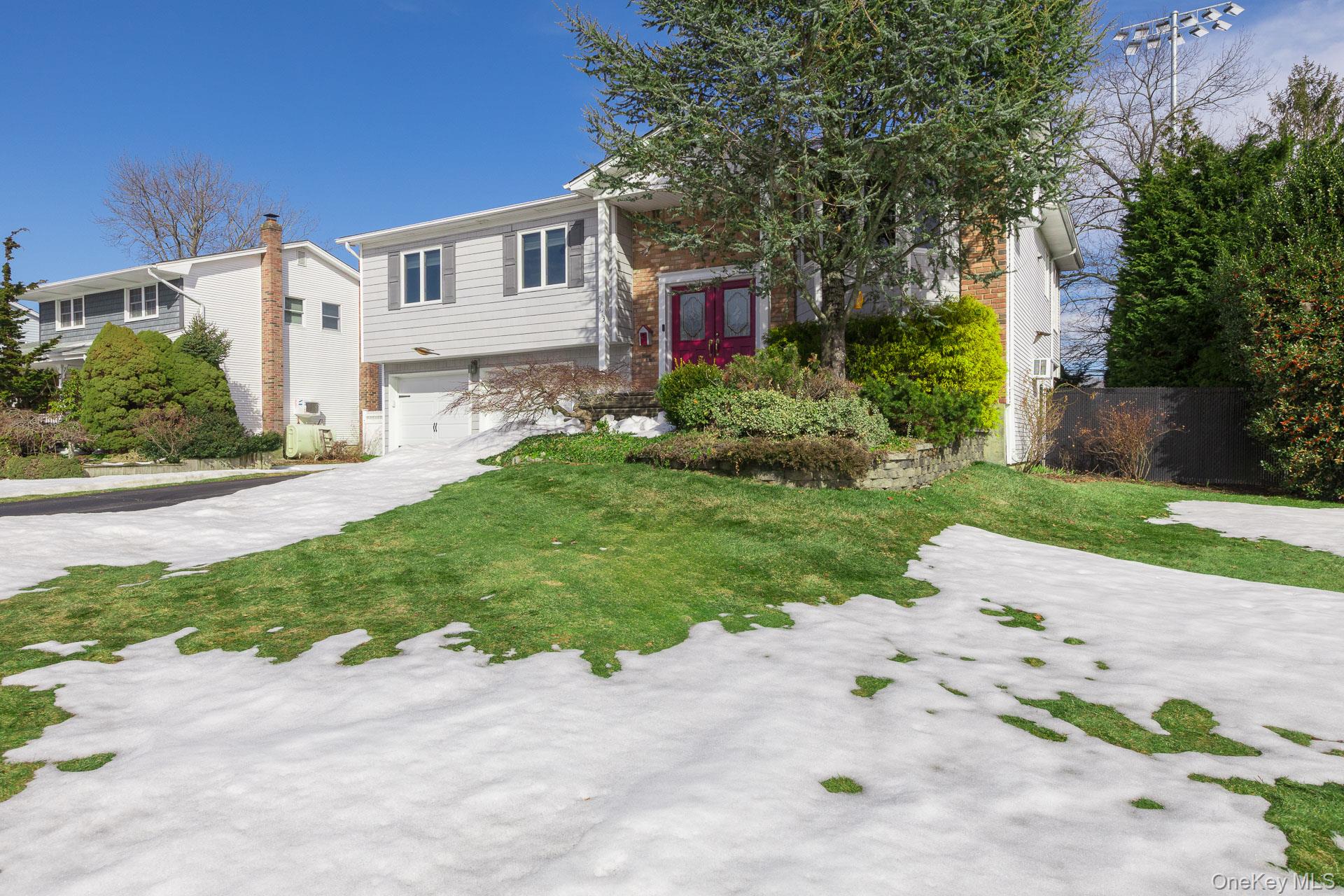 173 Fifty Acre Road South Smithtown, NY 11787 - Photo 5 of 42 a front view of a house with a yard and a garage