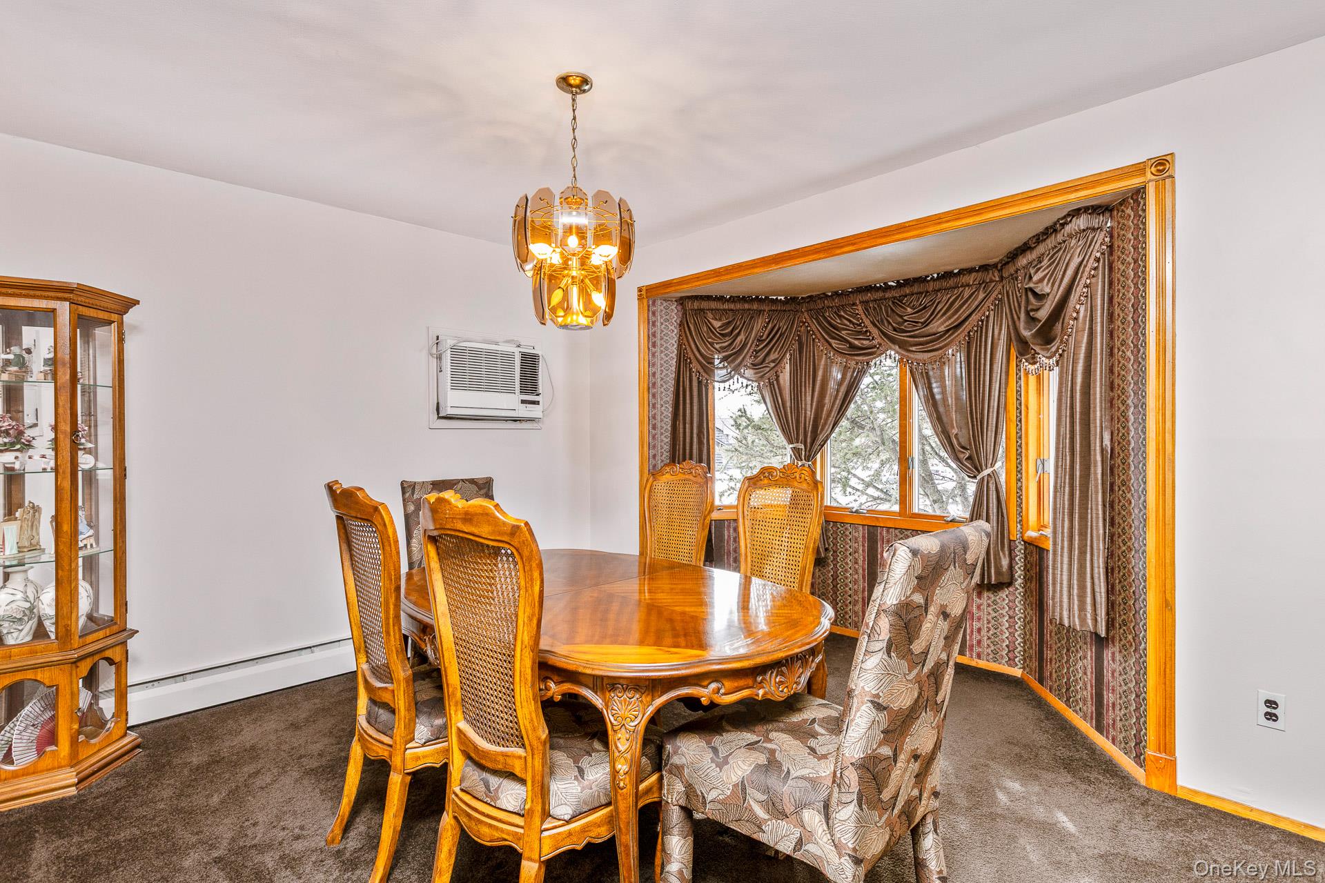 173 Fifty Acre Road South Smithtown, NY 11787 - Photo 8 of 42 a view of a dining room with furniture and chandelier