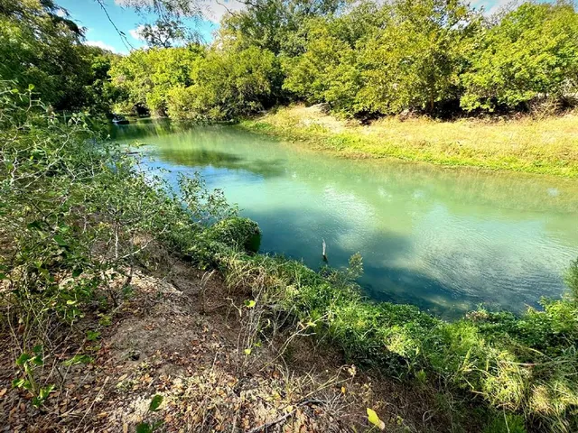 a view of a lake with a yard