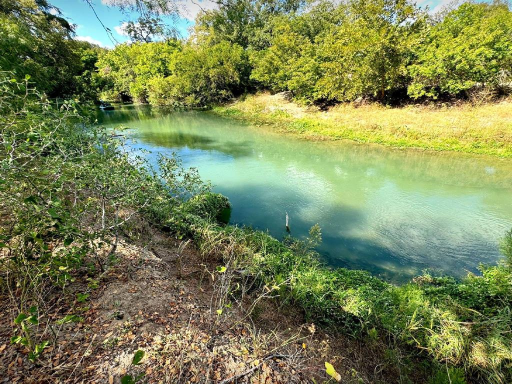 4194 Southeast River Road Martindale, TX 78655 - Photo 20 of 30 a view of a lake with a yard