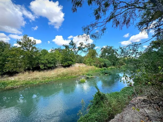 a view of a lake with a yard