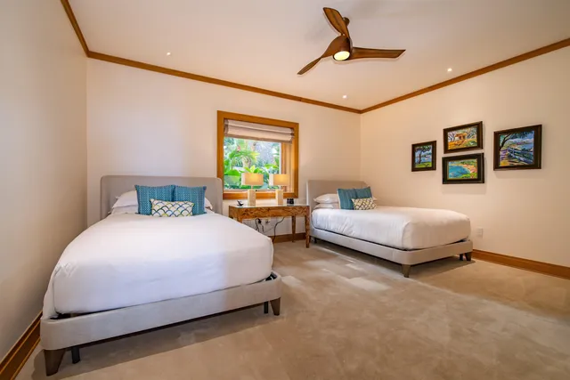 a bedroom with a bed a ceiling fan and a rug