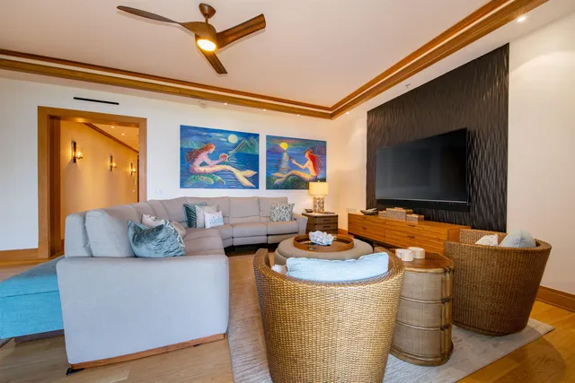 a dining room with furniture a chandelier and wooden floor