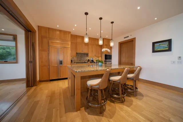 a kitchen with a table chairs sink and cabinets