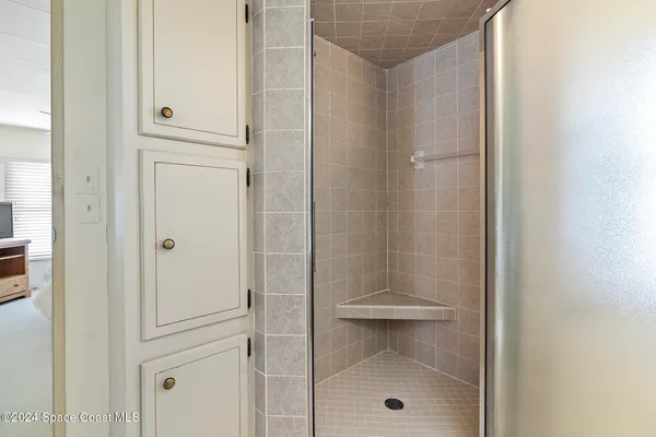 a bathroom with a glass shower door