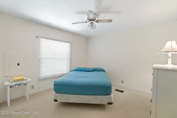a bedroom with a bed and a table