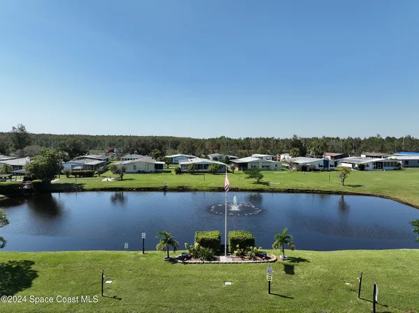 an aerial view of a house with a lake view