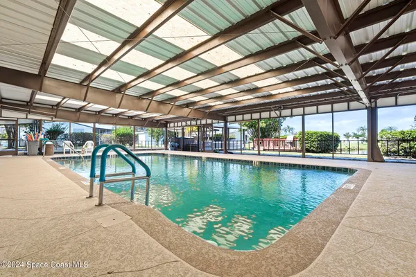 a view of a swimming pool with a yard