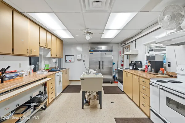 a kitchen with a table chairs stove and cabinets
