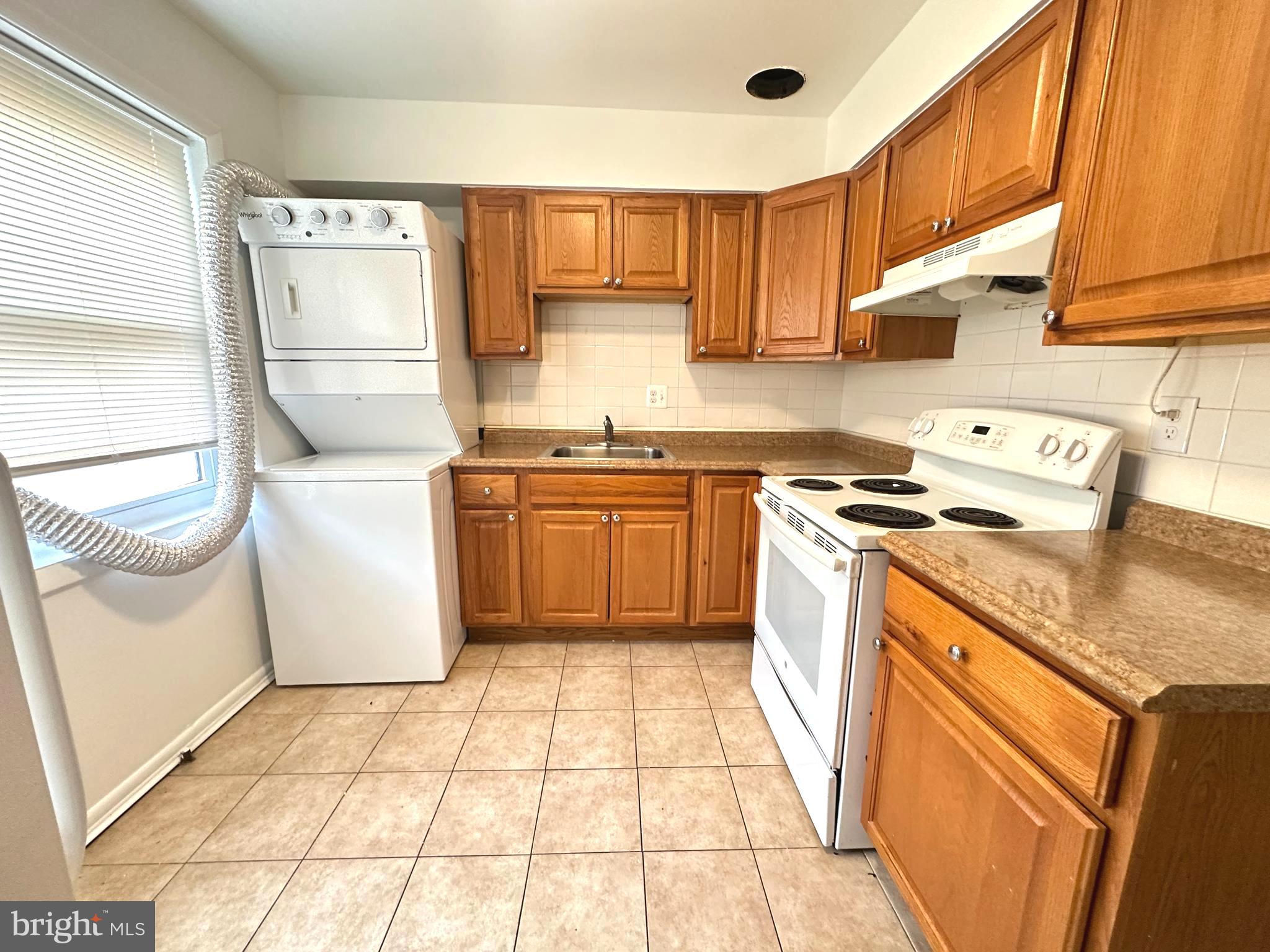4254 Buckman Road, Unit 5 Alexandria, VA 22309 - Photo 7 of 20 a kitchen with a sink a stove top oven and cabinetry