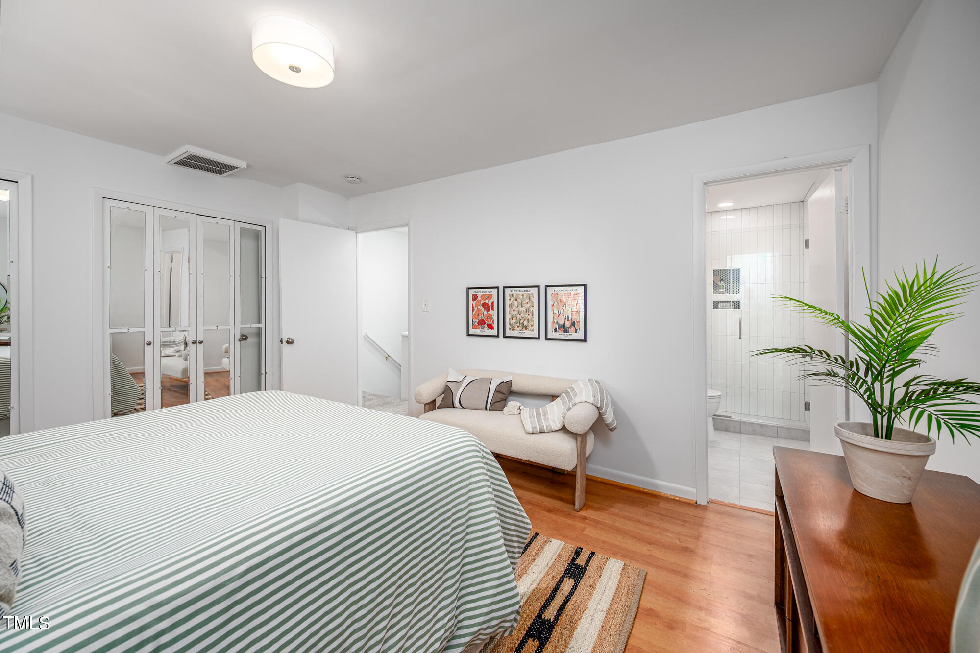 906 Oak Tree Drive Chapel Hill, NC 27517 - Photo 13 of 22 a bedroom with a bed and wooden floor