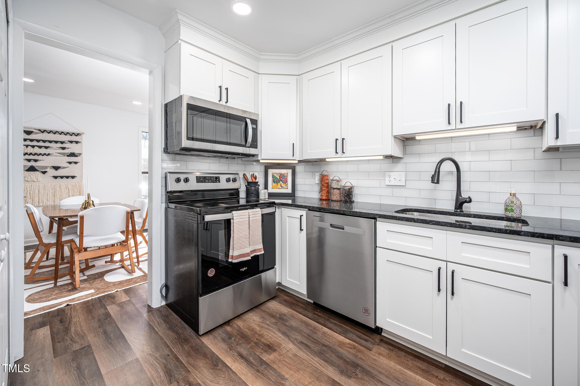 906 Oak Tree Drive Chapel Hill, NC 27517 - Photo 7 of 22 a kitchen with granite countertop a sink cabinets and stainless steel appliances
