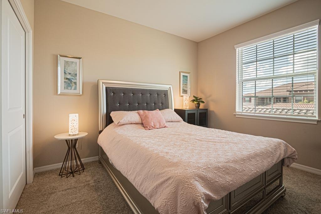 9378 Pocida Court, Unit 202 Naples, FL 34119 - Photo 41 of 41 a bed sitting in a bedroom next to a window