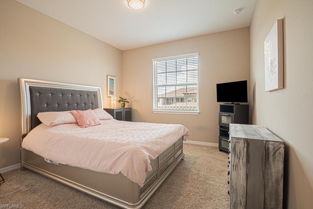 9378 Pocida Court, Unit 202 Naples, FL 34119 - Photo 16 of 42 Guest bedroom, neutral carpet & decor