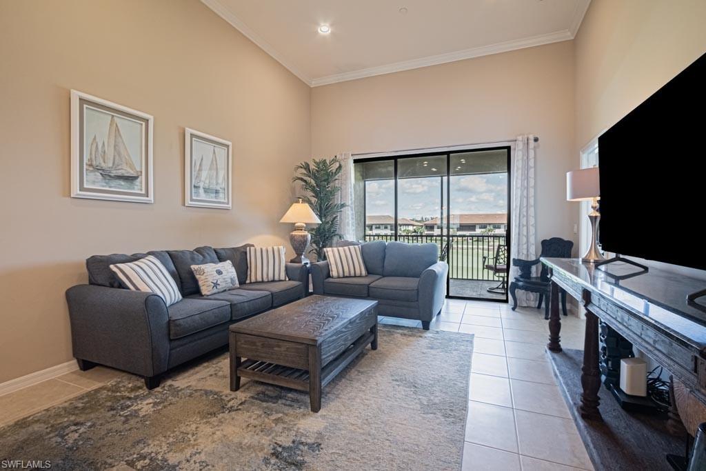 9378 Pocida Court, Unit 202 Naples, FL 34119 - Photo 21 of 41 a living room with furniture and a flat screen tv