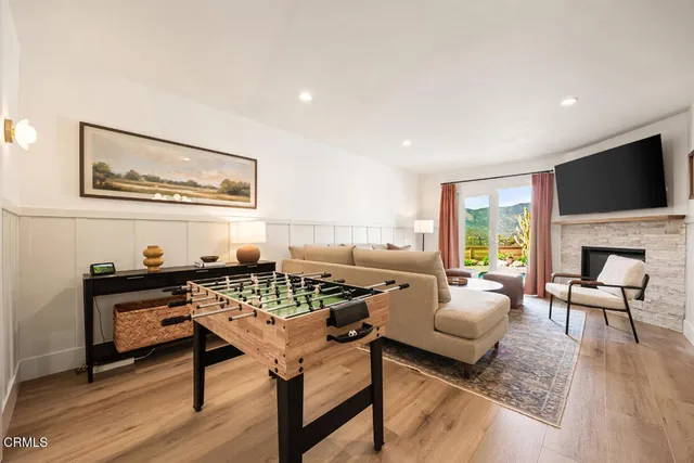 a front view of a house with a tree