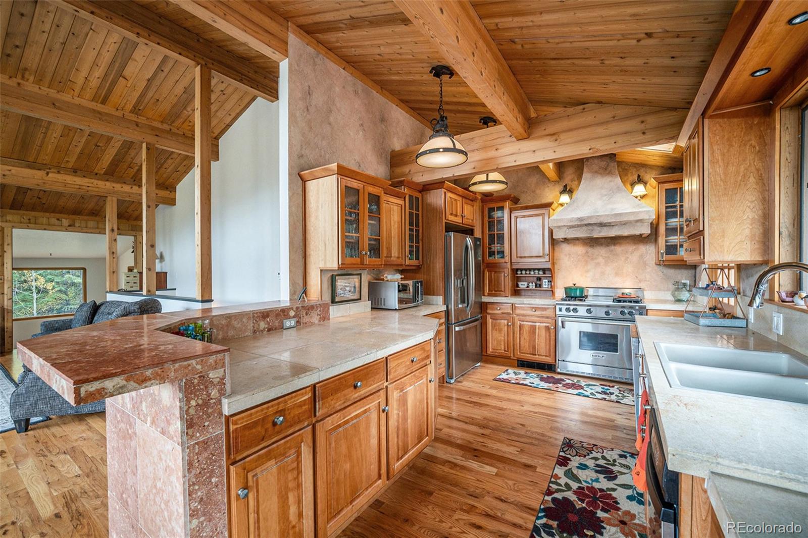 1774 Upper Bear Creek Road Evergreen, CO 80439 - Photo 13 of 43 a kitchen with sink stove and cabinets
