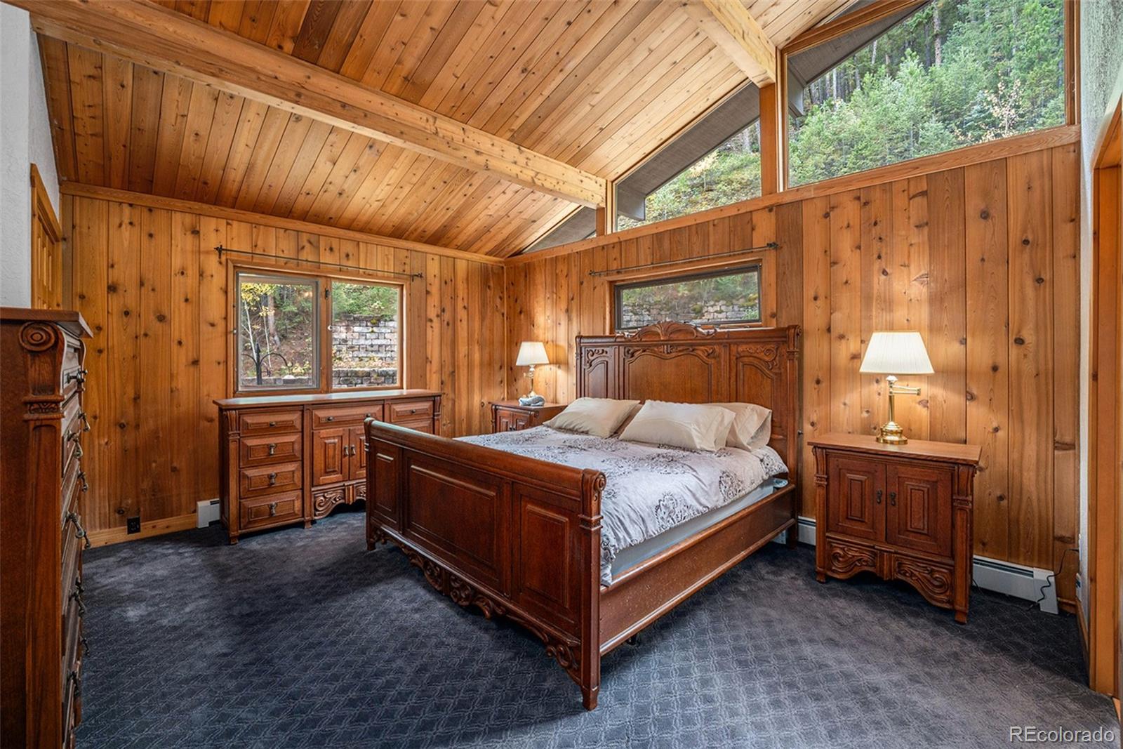 1774 Upper Bear Creek Road Evergreen, CO 80439 - Photo 16 of 43 a bed room with a bed and a window