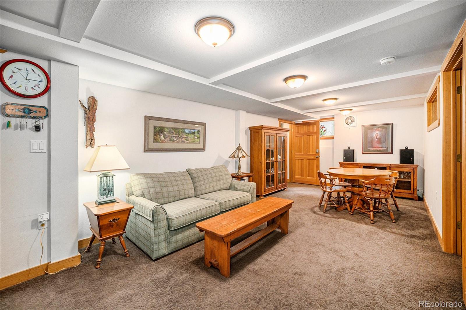 1774 Upper Bear Creek Road Evergreen, CO 80439 - Photo 25 of 43 a living room with furniture and a table