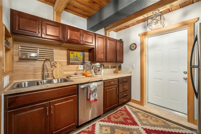 a kitchen with stainless steel appliances granite countertop a sink and cabinets