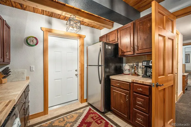 a kitchen with stainless steel appliances granite countertop a refrigerator and a stove