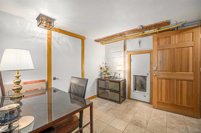 a dining room with furniture and a mirror