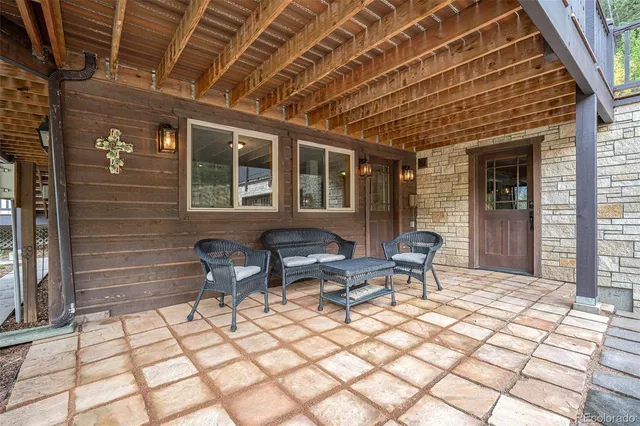a view of a patio with a table and chairs