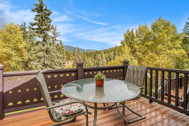 a view of a balcony with a table and chairs
