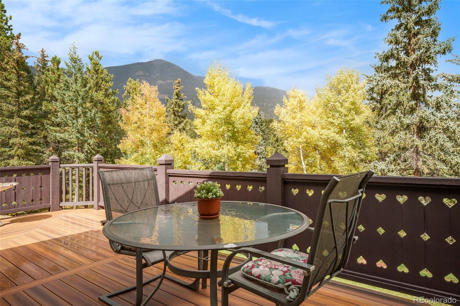 1774 Upper Bear Creek Road Evergreen, CO 80439 - Photo 37 of 43 a view of a balcony with furniture and a potted plant