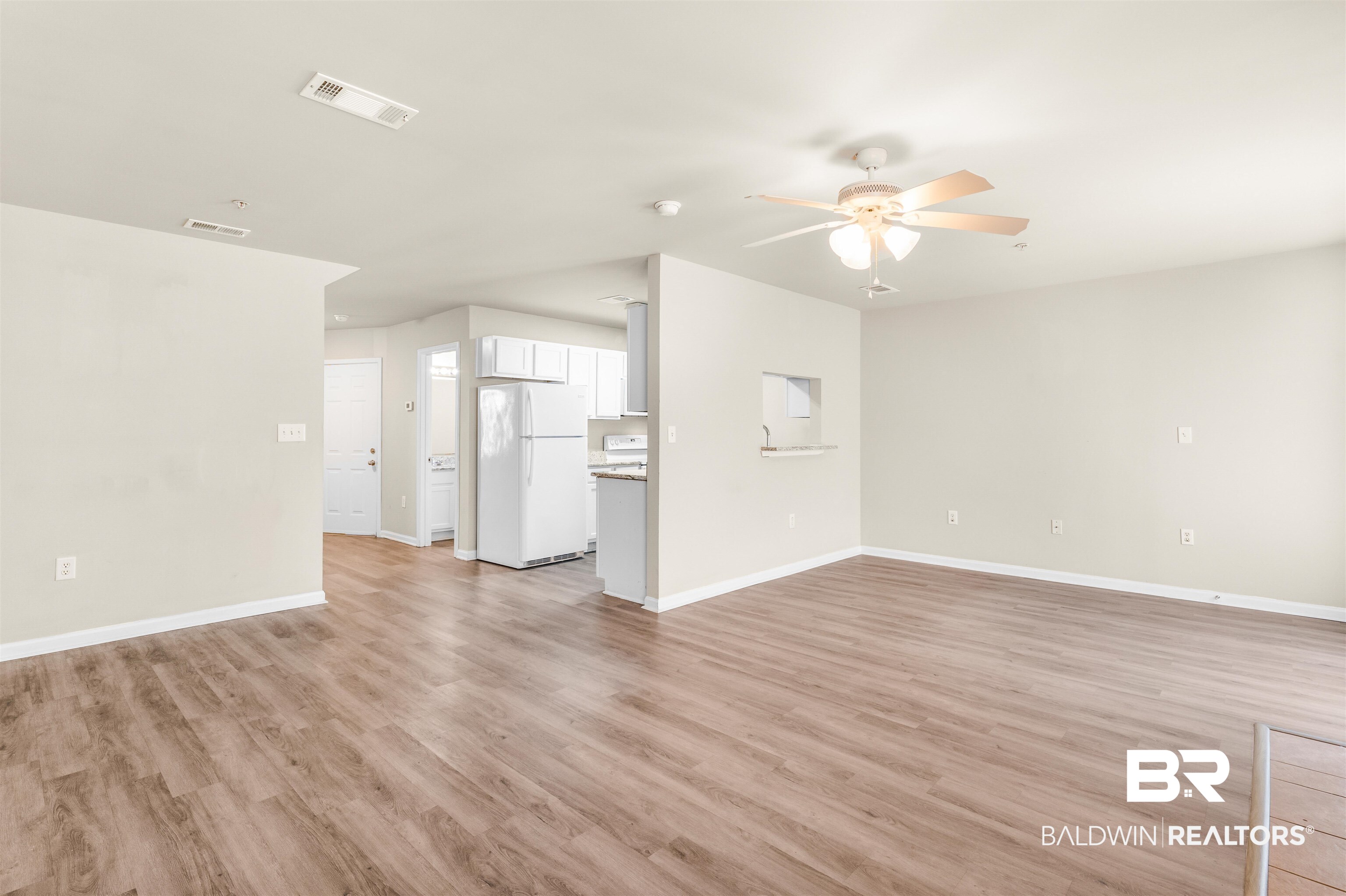 1517 Regency Road, Unit 85 Gulf Shores, AL 36542 - Photo 5 of 32 Unfurnished living room with ceiling fan and light hardwood / wood-style floors