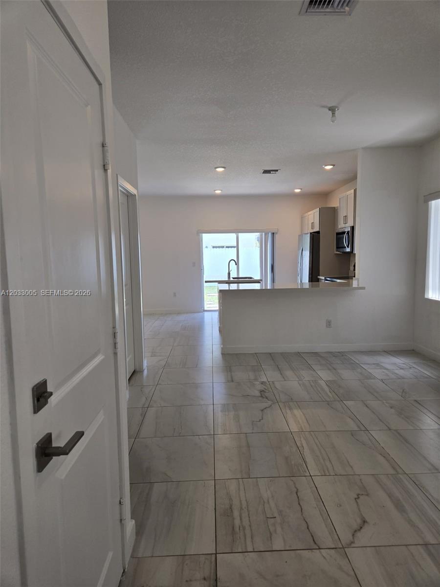 862 Southeast 17 Street, Unit 862 Homestead, FL 33034 - Photo 30 of 39 a view of a kitchen and an empty room