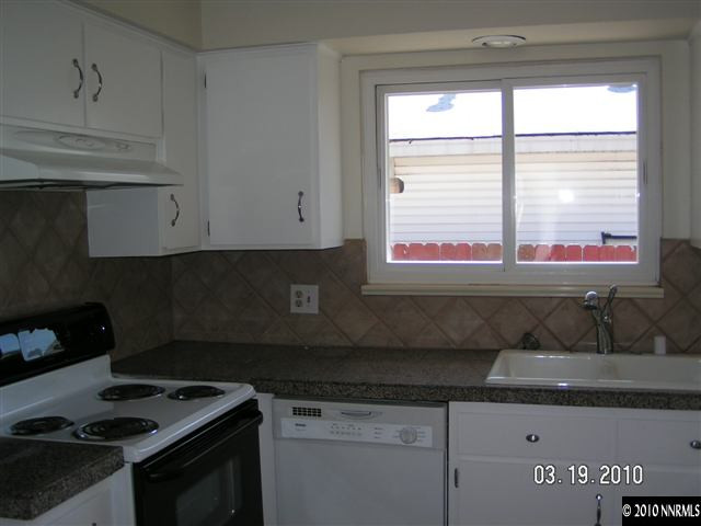 1010 Autumn Reno, NV 89511 - Photo 3 of 8 a kitchen with stainless steel appliances granite countertop a sink a stove and a microwave