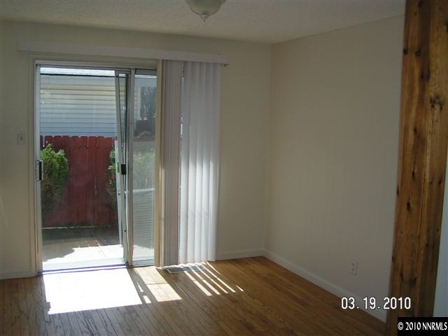 1010 Autumn Reno, NV 89511 - Photo 8 of 8 a view of an empty room with wooden floor and a window