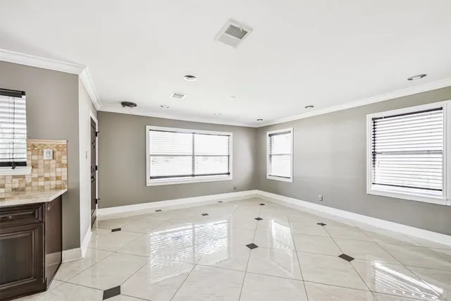 a large kitchen with granite countertop a stove top oven microwave and refrigerator