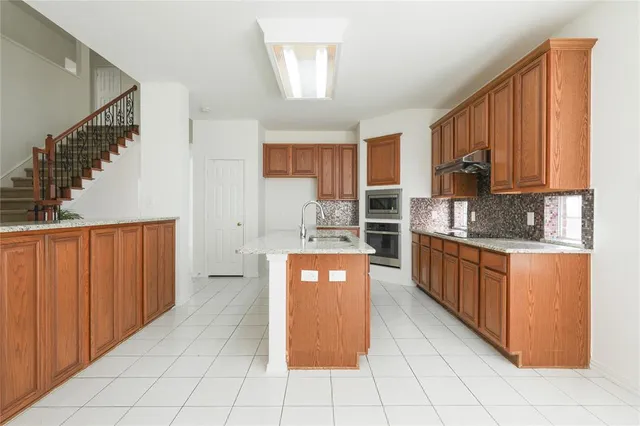 a kitchen with stainless steel appliances a refrigerator sink and cabinets