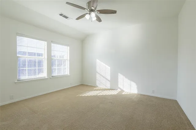 an empty room with a empty space and windows