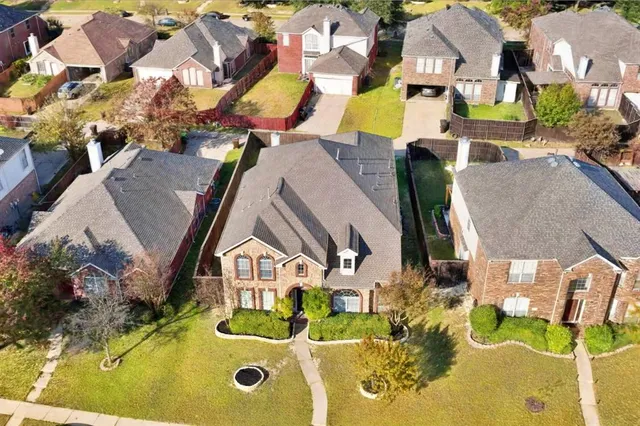 an aerial view of residential houses with outdoor space