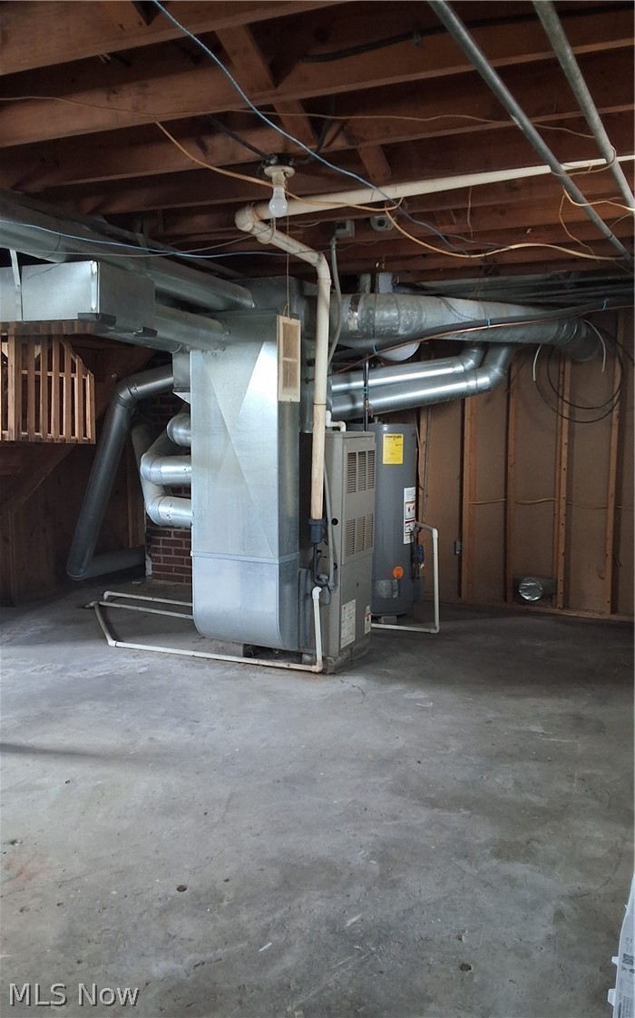 236 Bowland Road Mansfield, OH 44907 - Photo 17 of 34 Basement utility area featuring a furnace, hot water heater, exposed wood ceiling joists, ductwork, and concrete flooring