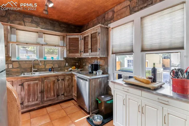 a kitchen with stainless steel appliances granite countertop a sink stove and cabinets