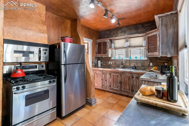 a kitchen with a refrigerator and a stove
