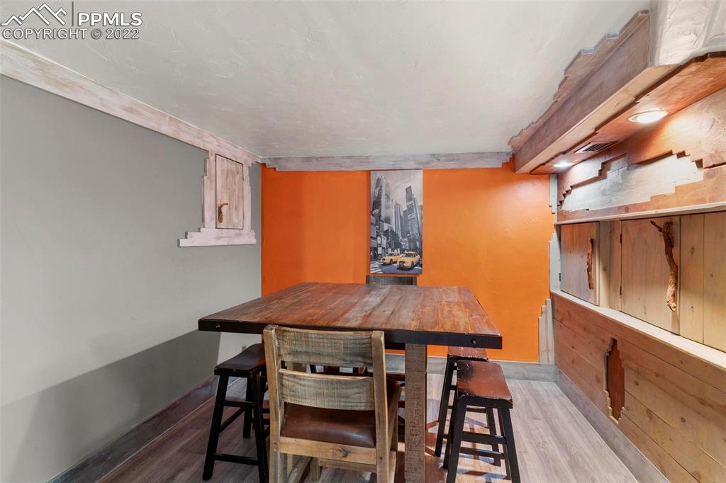 6 Alsace Way Colorado Springs, CO 80906 - Photo 19 of 30 a view of a dining room with furniture and wooden floor