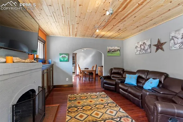 a living room with furniture a fireplace and a flat screen tv