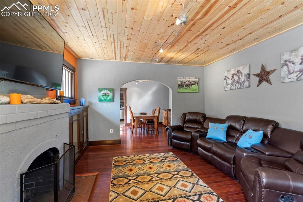 6 Alsace Way Colorado Springs, CO 80906 - Photo 3 of 30 a living room with furniture a fireplace and a flat screen tv