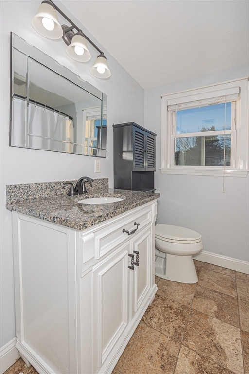 345 Cross Street Bridgewater, MA 02324 - Photo 16 of 27 a bathroom with a granite countertop sink a toilet and mirror