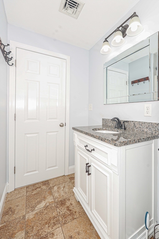 345 Cross Street Bridgewater, MA 02324 - Photo 17 of 27 a bathroom with a granite countertop sink and a mirror