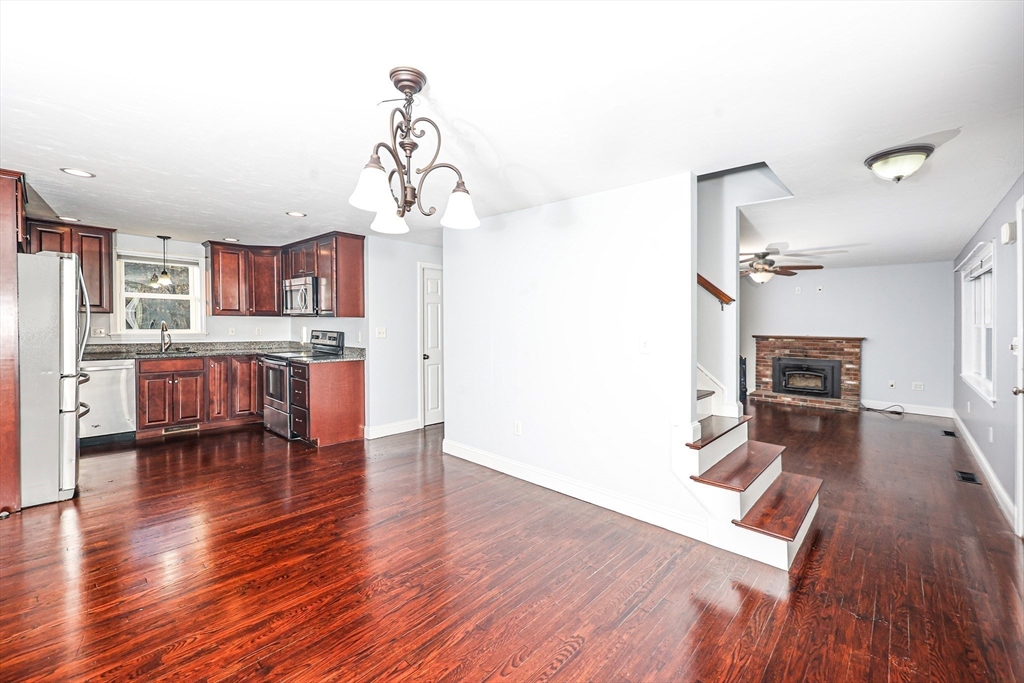 345 Cross Street Bridgewater, MA 02324 - Photo 2 of 27 a living room with stainless steel appliances furniture and wooden floor