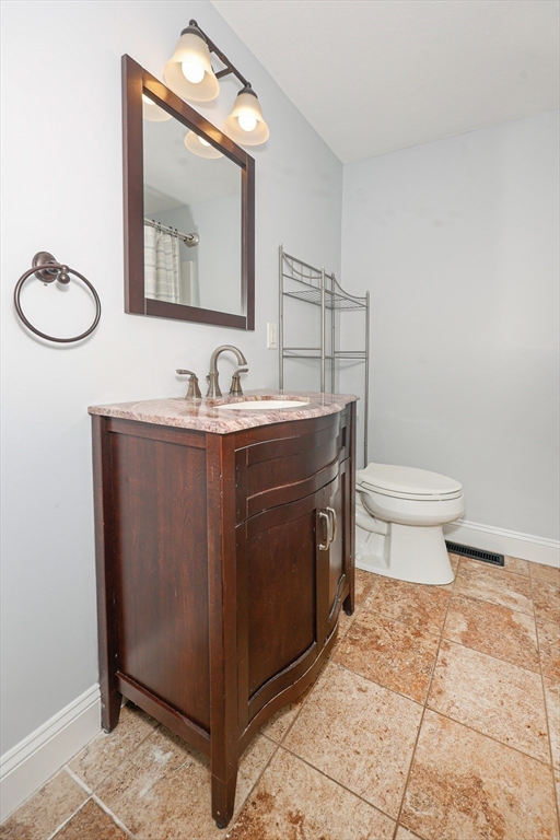 345 Cross Street Bridgewater, MA 02324 - Photo 5 of 27 a bathroom with a toilet a sink and mirror